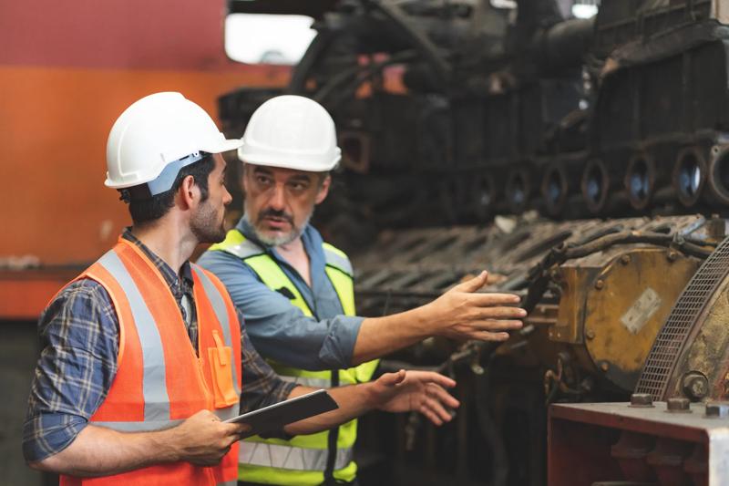COLOUR-IMAGE_construction-workers-machine-check_Apr26
