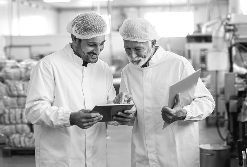 SINGLE-IMAGE_two-workers-in-food-factory-with-tablet_aug24