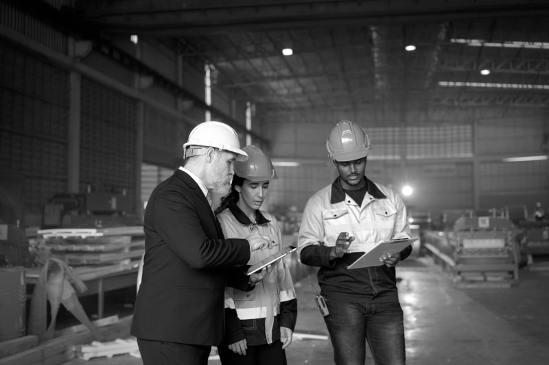 SINGLE-IMAGE_group-with-hard-hats-studying-tablet-and-clipboard_apr25