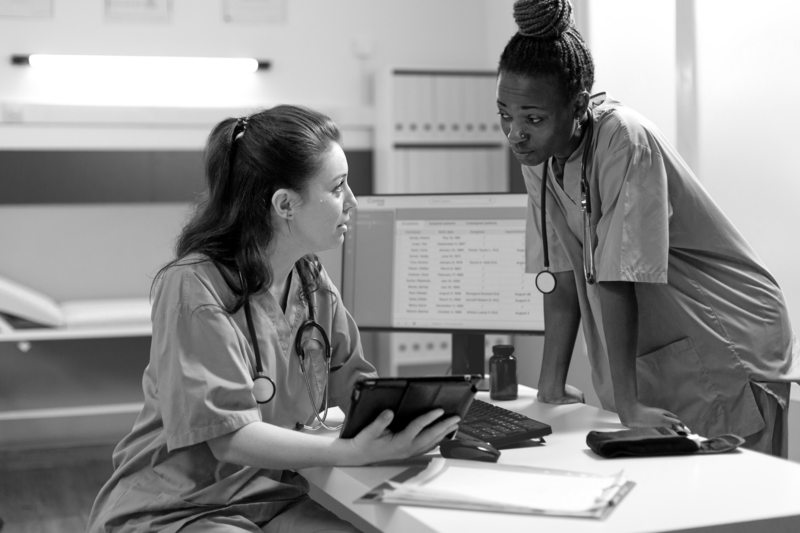 SINGLE-IMAGE_two-nurses-talking-over-tablet_sept24