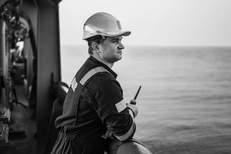 SINGLE-IMAGE_male-engineer-on-deck-holding-walkie-talkie_jul24