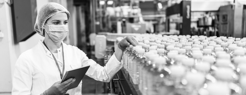 https://brandportal.ideagen.com/m/74ad53d7aead4ef9/webimage-SINGLE-IMAGE_woman-with-tablet-checking-bottles-on-conveyor_nov23.png